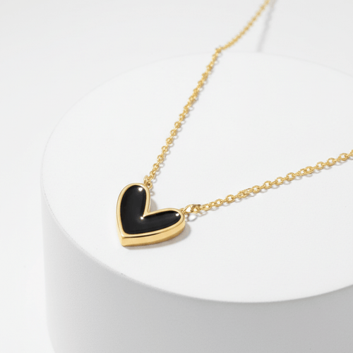Black Heart Necklace Gold necklace with a black heart pendant on a white background