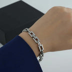 Ceyrah silver Bold Link Chain Bracelet on wrist, modern jewelry against dark box background