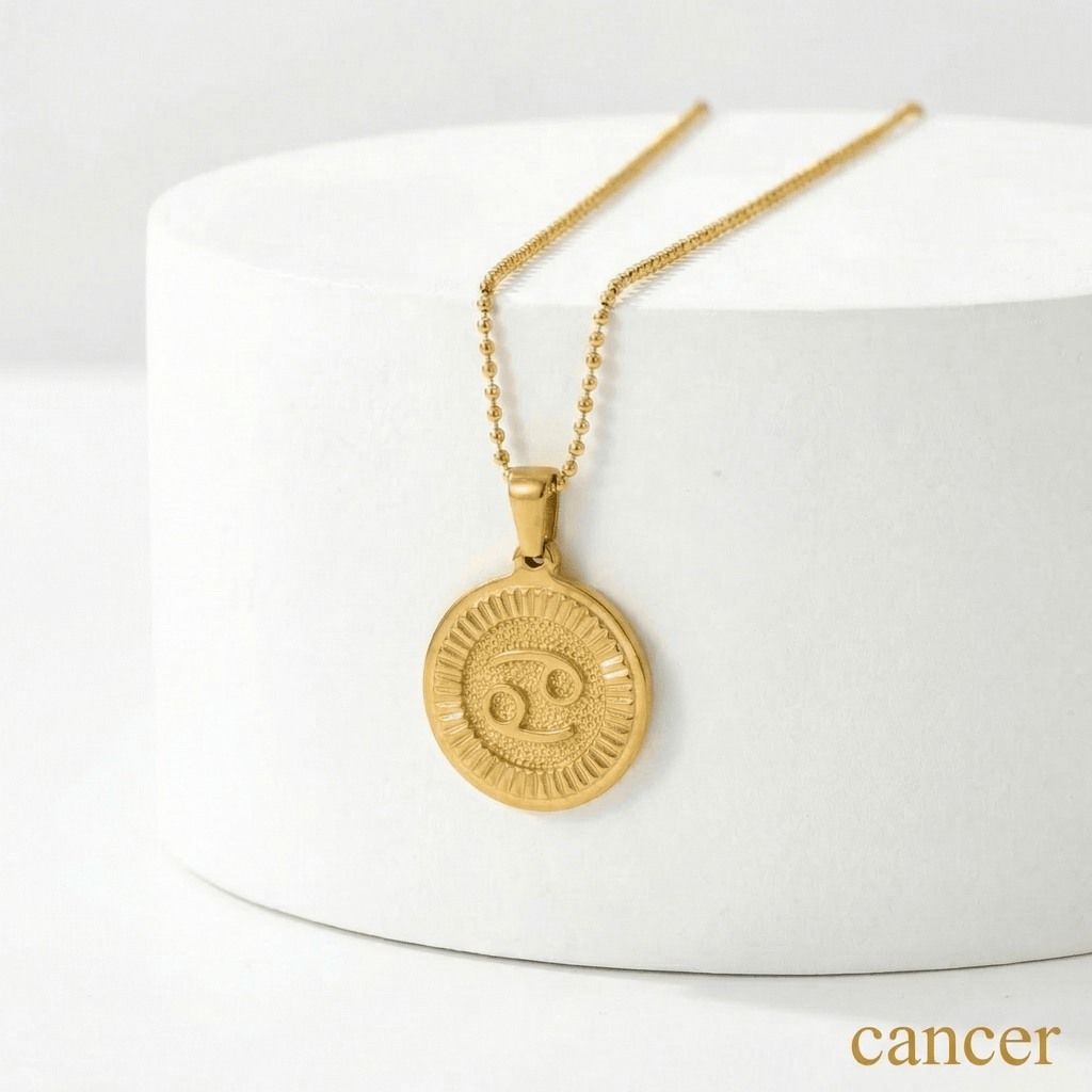 Zodiac Sign Medallion Necklace Gold with a Cancer zodiac sign pendant on a white surface