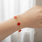 Gold Five Clover Bracelet with red floral motifs on a gold-tone chain worn on a wrist.