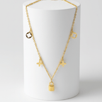 Clover Charm Necklace with Lock Pendant on a white cylindrical stand against a light gray background