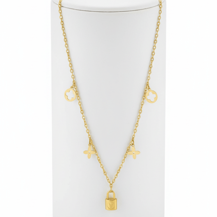 Clover Charm Necklace with Lock Pendant on a white cylindrical stand