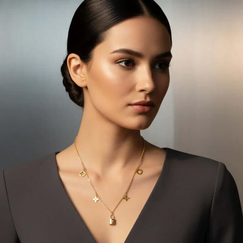 Ceyrah Clover Charm Necklace with Lock Pendant on woman in grey v-neck top, minimalist background