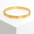 Clover Engraved Diamond Bangle Bracelet on pedestal
