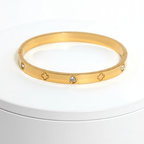 Clover Engraved Diamond Bangle Bracelet on white pedestal 