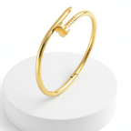 Clover Nail Bangle Bracelet on a white round base with a white background