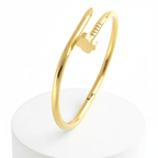 Clover Nail Bangle Bracelet on a white cylindrical stand with a white background