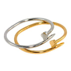 Clover Nail Bangle Bracelet Two gold and silver bangles on a white background