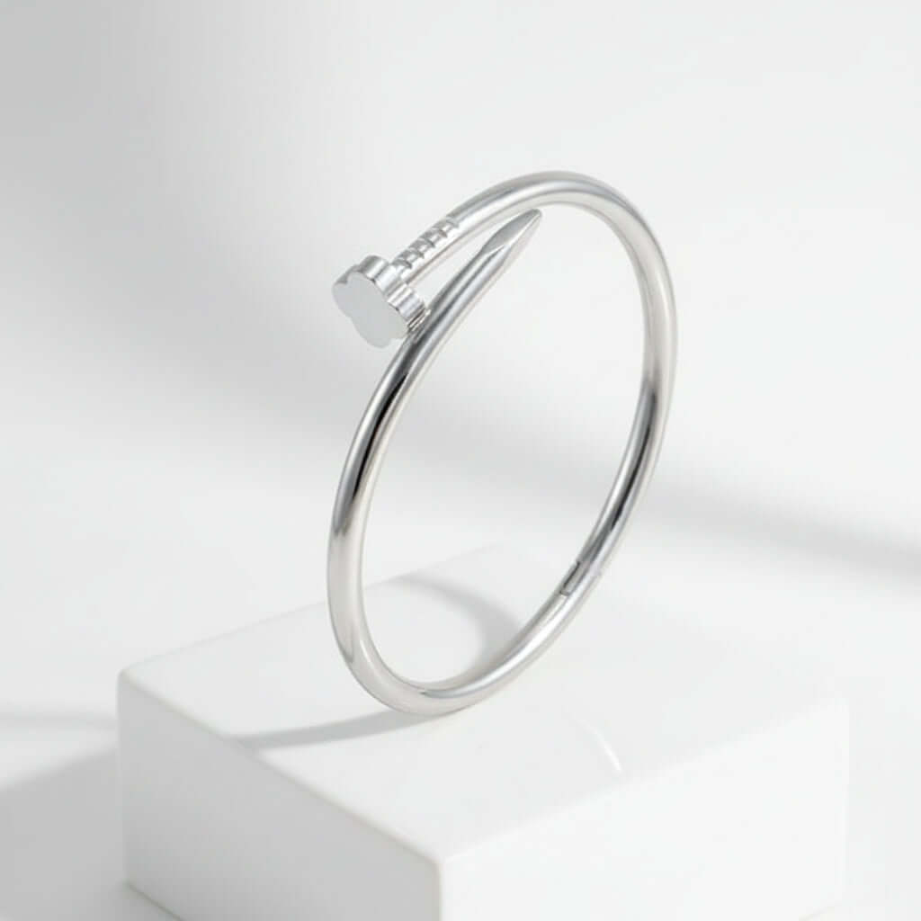 Clover Nail Bangle Bracelet in sleek silver finish, showcasing modern design and elegant style on a display.
