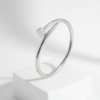 Clover Nail Bangle Bracelet in sleek silver finish, showcasing modern design and elegant style on a display.