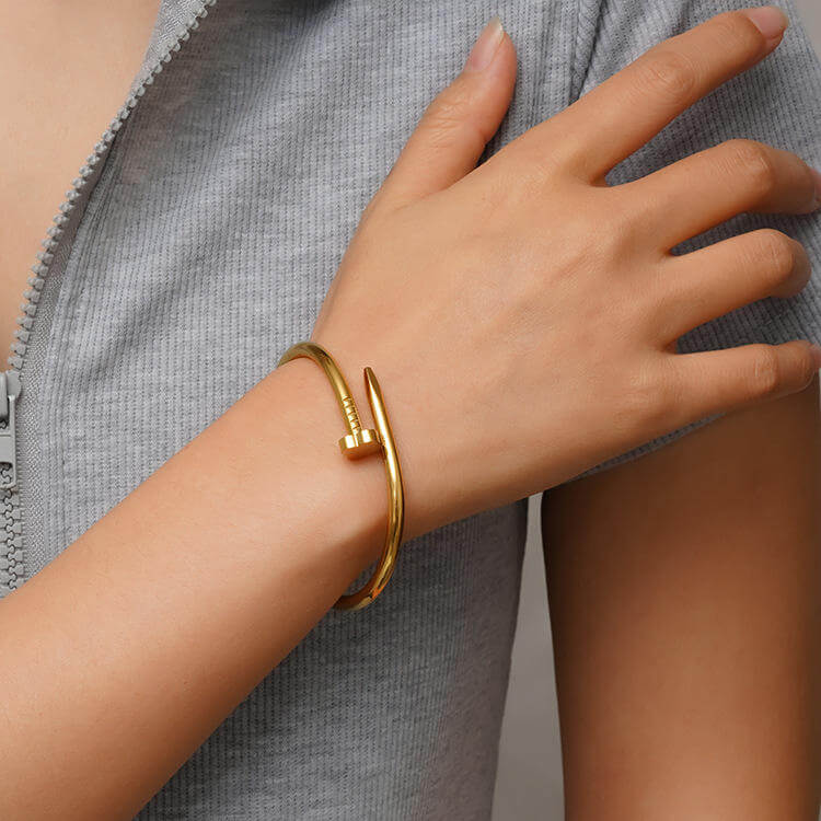Clover Nail Bangle Bracelet on a wrist with a neutral background