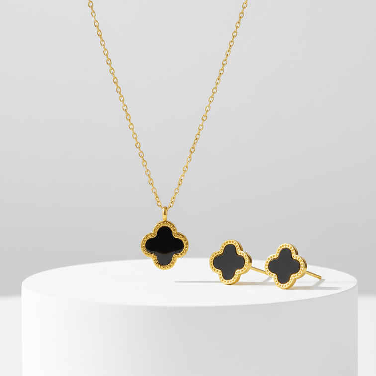 Clover Necklace and Earrings Set  on a white pedestal against a light gray background