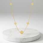 Clover Square Gold Necklace on marble platform 