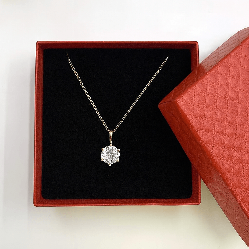 Gift Box with Necklace featuring a delicate gold chain and white diamond pendant in elegant packaging.