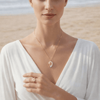 Gold Conch Shell Pendant Necklace worn by a model on the beach, showcasing coastal elegance and design.