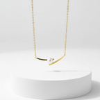 Cross Pearl Gold Necklace on white pedestal