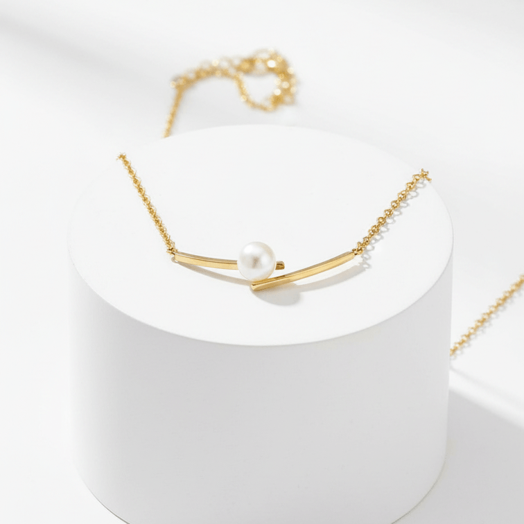Cross Pearl Gold Necklace on pedestal 
