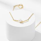 Cross Pearl Gold Necklace on pedestal 