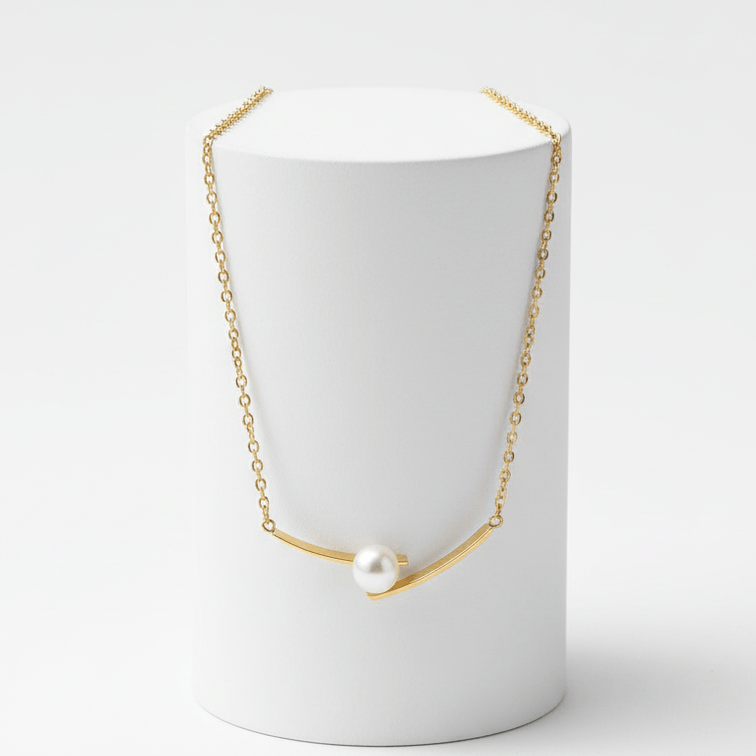 Cross Pearl Gold Necklace on white pedestal