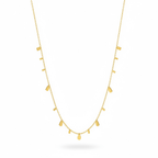 Gold necklace with small pendant drops on a white background