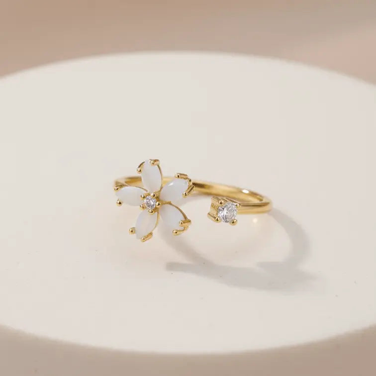 Dainty Bloom Open Gold Adjustable Ring on a beige background