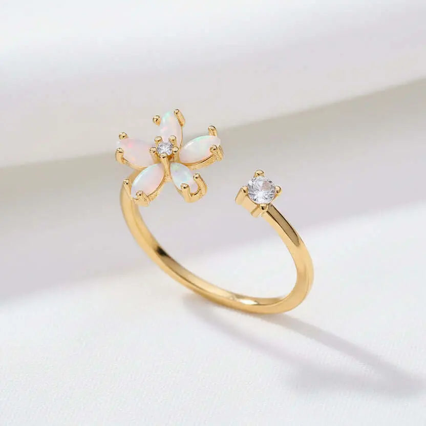 Dainty Bloom Open Gold Adjustable Ring with butterfly design on a beige fabric background