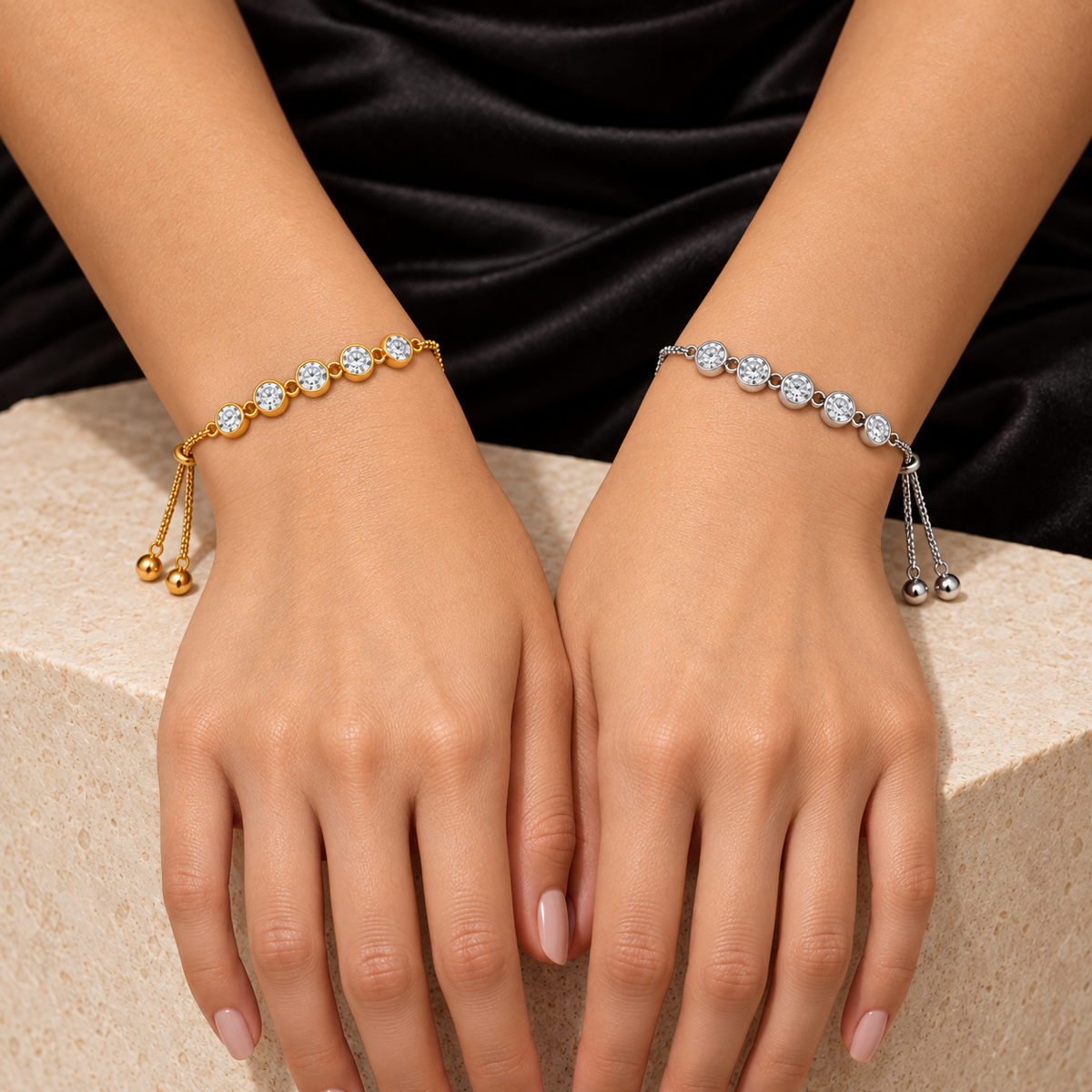 Two delicate Five-Stone Crystal Bolo Bracelet are shown on a model's wrists. One bracelet is gold-toned with clear floral beads, and the other is silver-toned with clear floral beads.