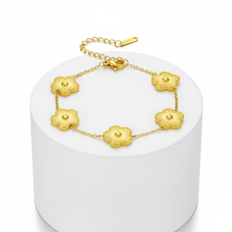 Five Leaf Clover Bracelet with golden clover charms on a minimalist display pedestal.