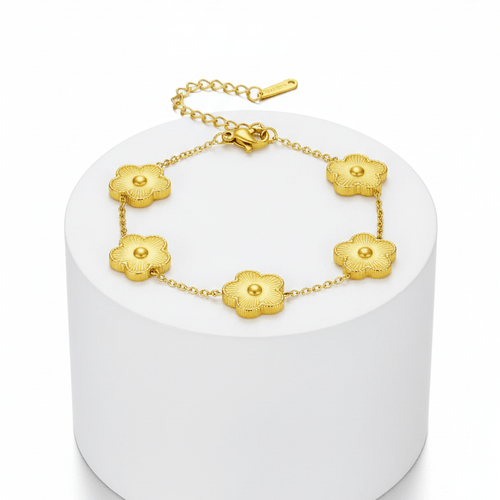 Five Leaf Clover Bracelet with golden clover charms on a minimalist display pedestal.