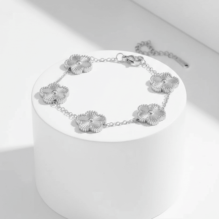 Silver Five Leaf Clover Bracelet on a white pedestal against a white background