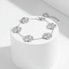Silver Five Leaf Clover Bracelet on a white pedestal against a white background