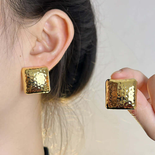 Geometric Square Stud Earrings worn and held up to the ear.