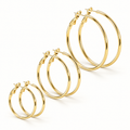 three pairs of Waterproof Trio of Classic Hoop Earrings in different sizes, arranged diagonally on a clean white background.