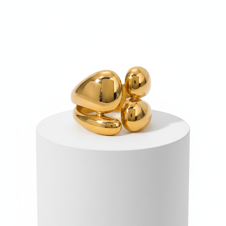 Gold Abstract Statement Ring on white pedestal