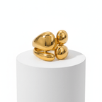 Gold Abstract Statement Ring on white pedestal
