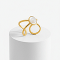 Gold Adjustable Pearl Ring with a pearl on a white pedestal against a white background
