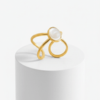 Gold Adjustable Pearl Ring with a pearl on a white pedestal against a white background