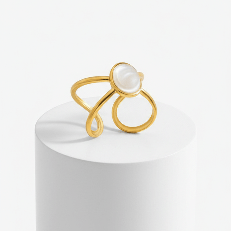 Gold Adjustable Pearl Ring with a pearl on a white pedestal against a white background