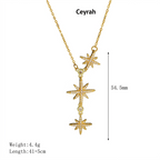 Gold Celestial Star Drop Necklace with three dangling starburst pendants, shown on a neutral gray background with overlaid text listing the name 'Ceyrah' and dimensions/weight.