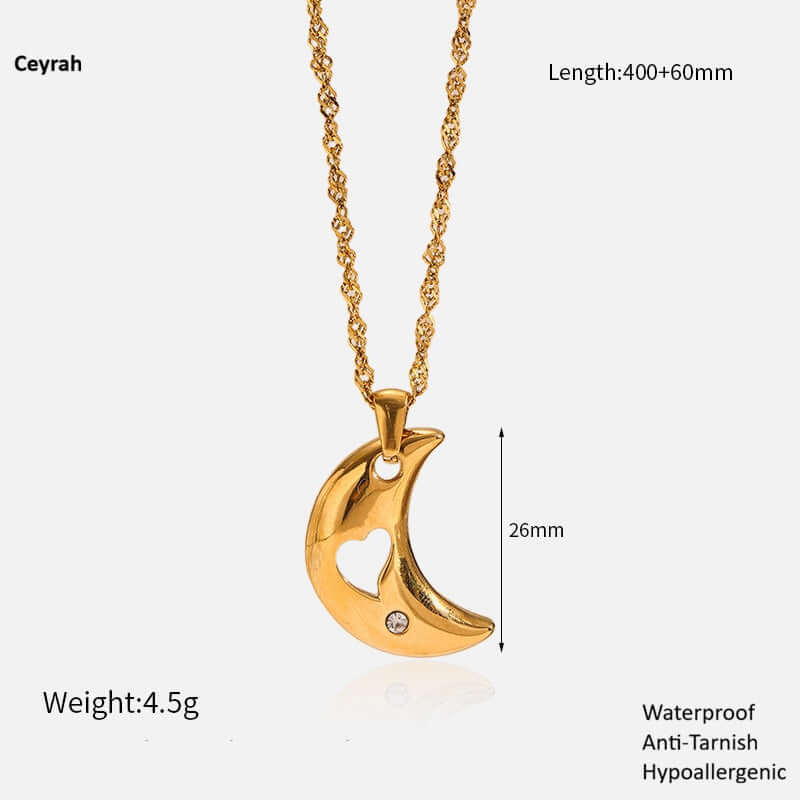 Gold Crescent Moon Necklace with heart cutout on a white background, featuring Ceyrah branding.