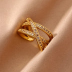 Gold Criss Cross Zircon Adjustable Ring with intricate design on a beige fabric background