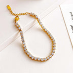 Gold Crystal Tennis Classic Bracelet with clear stones on a light background