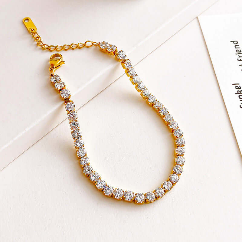 Gold Crystal Tennis Classic Bracelet with clear stones on a light background