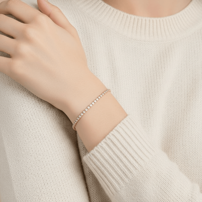 Woman wearing a beige sweater and Gold Crystal Tennis Mini Bracelet against a beige background