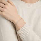 Woman wearing a beige sweater and Gold Crystal Tennis Mini Bracelet against a beige background
