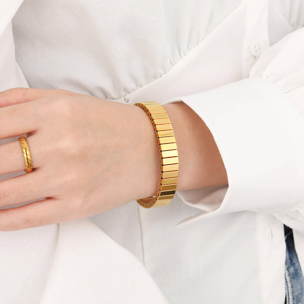 Gold Elastic Stainless Steel Bracelet on a wrist with a white shirt background