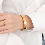 Gold Elastic Stainless Steel Bracelet on a wrist with a white shirt background