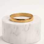 Gold Elastic Stainless Steel Bracelet with a gold rim on a white background