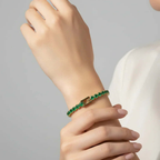 Ceyrah gold Emerald Green Tennis Bracelet on woman's wrist.