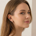 Close-up of a woman wearing colorful Gold Enamel Huggie Hoop Earrings with a neutral background